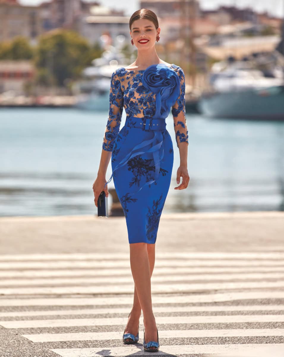 Robe bleue en dentelle avec détails floraux, parfaite pour une occasion spéciale ou une sortie en ville, mettant en valeur la silhouette avec un design sophistiqué et tendance.