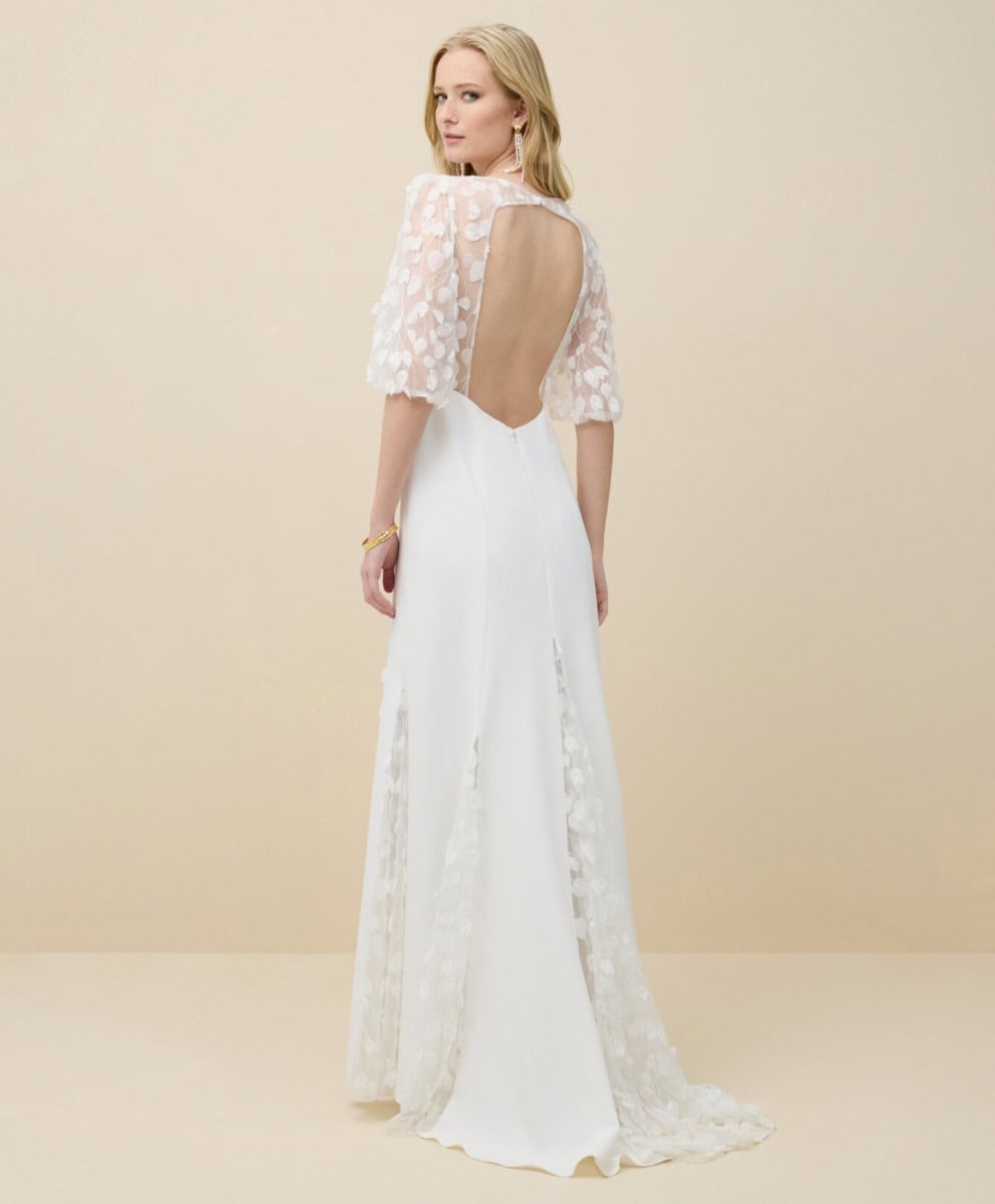Tunique de mariée élégante avec dos nu en dentelle florale, longue traîne et détails raffinés, parfaite pour une cérémonie sophistiquée et romantique.