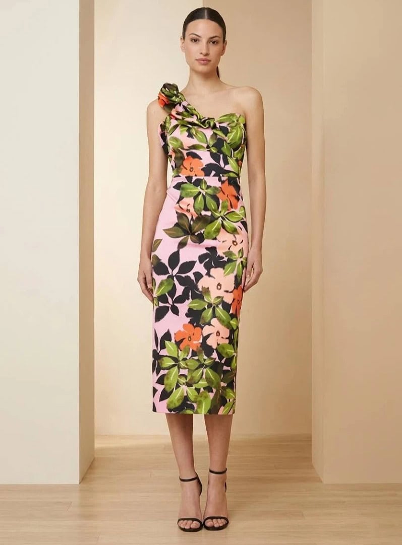 Robe longue à motif floral coloré, style élégant et moderne, portée par un mannequin dans un décor minimaliste.