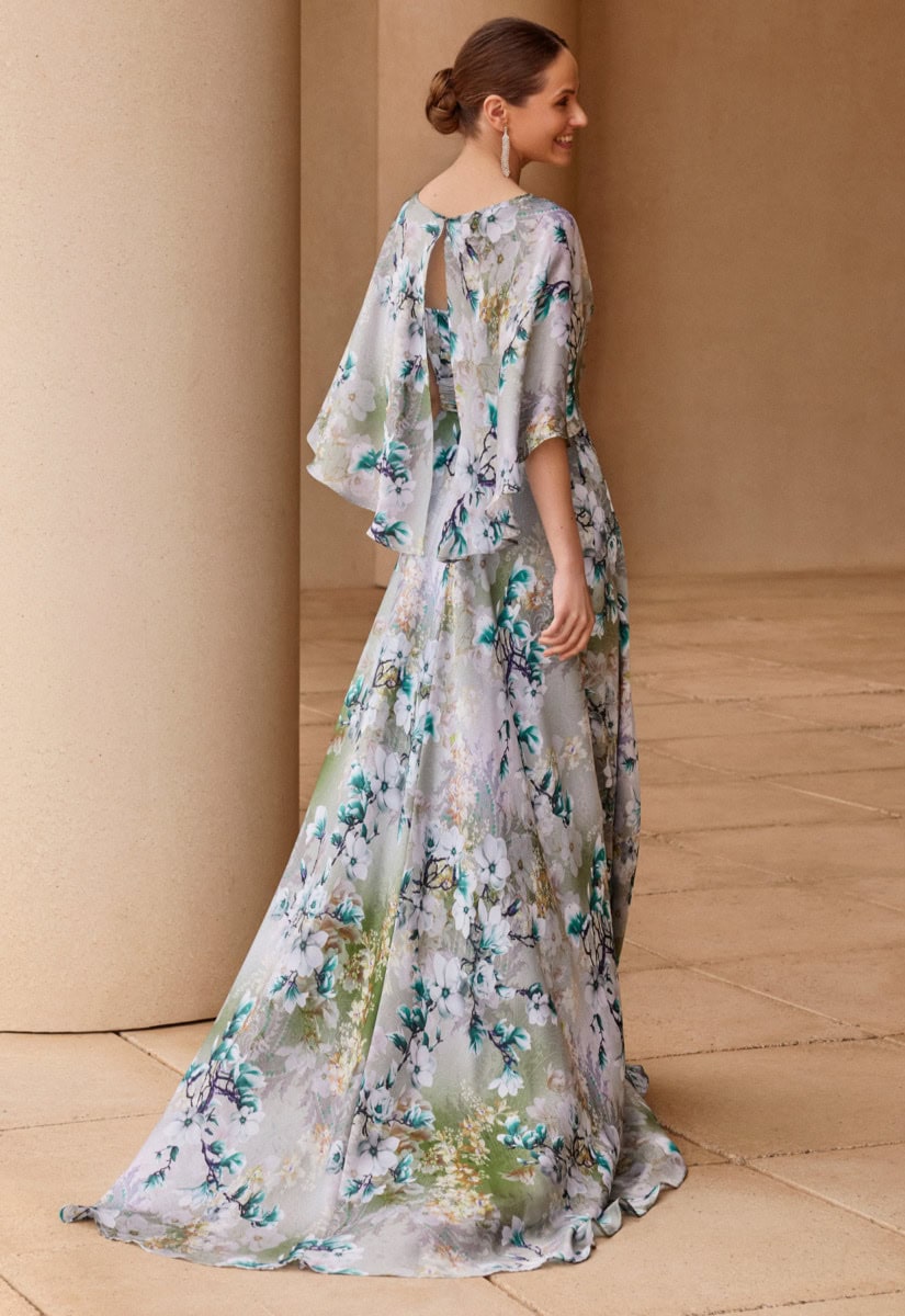 Femme portant une robe longue fluide à motifs floraux dans un style élégant et bohème.